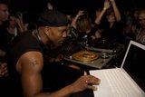 Man in Black Shirt Gets Ready to DJ