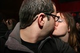 Two Glasses-Wearing Strangers Share a Kiss