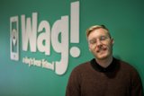 A Stylish Man Sporting Glasses and a WAG Logo