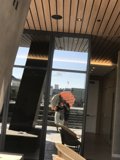 Umbrella Lady in Plywood Building