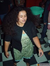 Curly-haired woman in denim and jewelry
