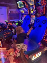 Child Playing Virtual Reality Motorcycle Racing Game in Arcade