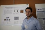 Jacopo Venturiero Standing Next to Poster