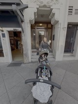 Mother with Double Stroller Outside Historic Building