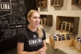 A Woman Poses with Coffee Display at a Los Angeles Shop