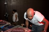 Groovy Deejay Mixing Music with Headphones at Party