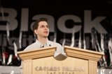 Jeff M delivering a speech at a podium