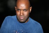 The Blue-Shirted Bald Man