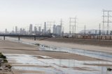 Urban river and electric transmission tower