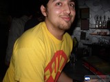 Yellow-shirted man enjoys a night out at the pub