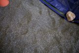 A Rock and a Tarp on Gravel Flooring