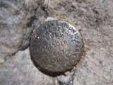 Tossed Nickel on Rocky Terrain