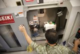 Factory Worker Busy at Machine