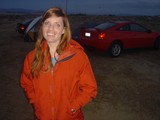 Woman Smiling at Desert Campsite at Dusk
