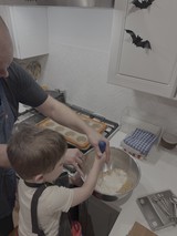 Parent and Child Baking Together in Kitchen