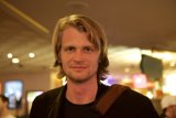 Long-haired man in a cozy pub