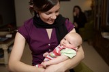New Mother Lovingly Cradles Her Newborn Baby