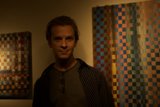 Standing before a wall of art