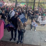 Couple Poses in Front of Vibrant Pink Sign in LA