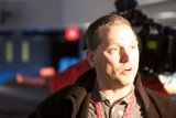 Jacketed Man Talks to Camera