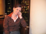 Smiling Woman at Urban Bar with City Lights