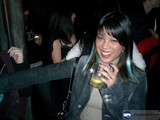 Blue-haired Woman Sipping a Drink at the Club