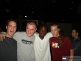 Three Young Men Strike a Pose at a Party