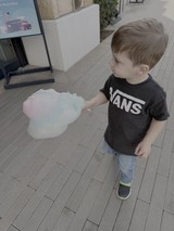 Young Child Enjoys Colorful Cotton Candy Treat