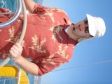 Sailor Style: Man Wearing a Blue Hat on the Open Sea
