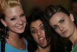 Three Women Decked Out in Accessories Strike a Pose at Night Club