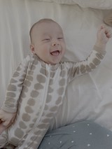 Joyful Baby Laughing in Polka Dot Sleepwear