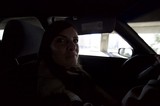 Woman Behind the Wheel in Dramatic Urban Shadows