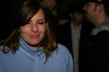 Woman Smiling Candidly at Nighttime Outdoor Gathering