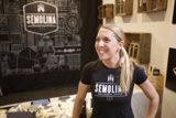 Blonde Teen in Black T-Shirt Poses in Front of Display