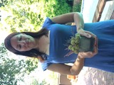 Woman in Blue Dress Holds Floral Arrangement Outdoors