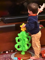 Toddler Playing with Bright Christmas Tree Toy