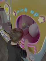 Child Playing with Interactive Arcade Game
