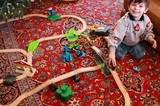 Young Boy Playing with Wooden Train Set on Christmas