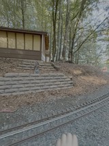 Modern House with Stone Retaining Wall and Railroad Tracks
