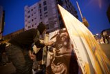 Urban Artist Creates Mural Amidst Blue Skies