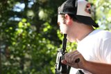 The Armed Man in the Baseball Cap