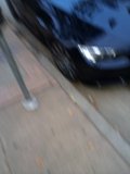Spoked Alloy Wheel in Parked Car