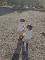 Two Young Boys Playing with Yellow Toy Truck