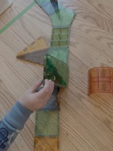 Child Playing with Colorful Magnetic Building Tiles