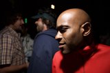 Bald man in a red shirt with his crew