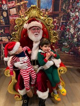 Two Children Visit Santa in His Workshop Grotto