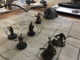 Miniature Warriors Battle on Wooden Table