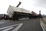 Crane Lifts Overturned Truck from Tarmac