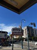 Burger Joint Sign in City Street Intersection
