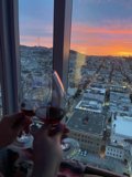 Sipping Red Wine Above the Urban Metropolis